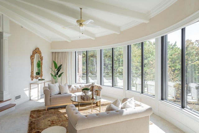 sunroom / solarium featuring ceiling fan and lofted ceiling with beams