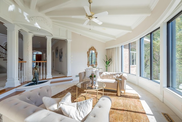 sunroom / solarium with lofted ceiling with beams, ceiling fan, and ornate columns