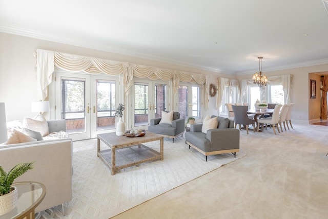 living room with an inviting chandelier, light colored carpet, crown molding, and french doors