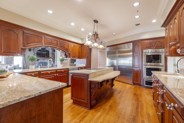 kitchen with a center island, sink, tasteful backsplash, decorative light fixtures, and stainless steel appliances