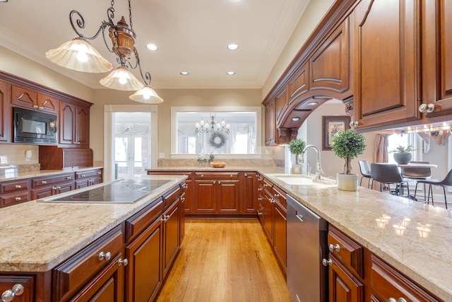 kitchen with crown molding, sink, black appliances, an inviting chandelier, and hanging light fixtures