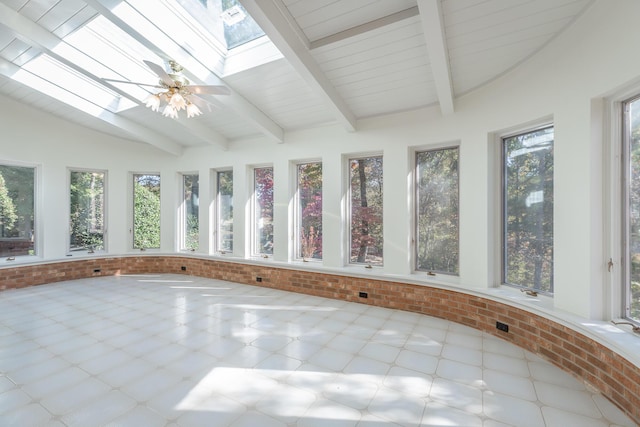 unfurnished sunroom with ceiling fan and lofted ceiling with skylight