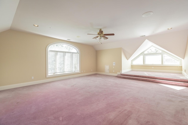 bonus room featuring ceiling fan, plenty of natural light, and vaulted ceiling