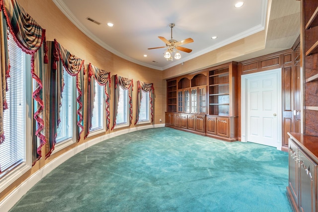 unfurnished living room with crown molding, carpet, and ceiling fan