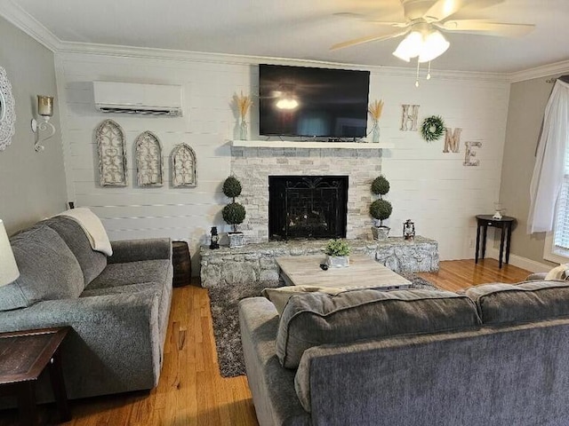 living room with ceiling fan, hardwood / wood-style floors, a wall mounted air conditioner, and ornamental molding