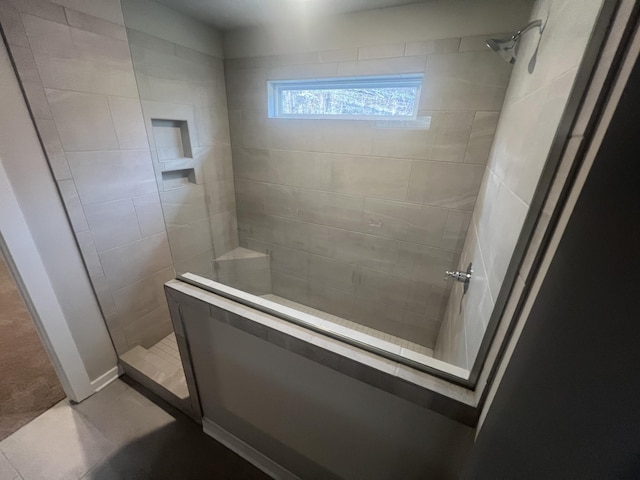 bathroom with a tile shower