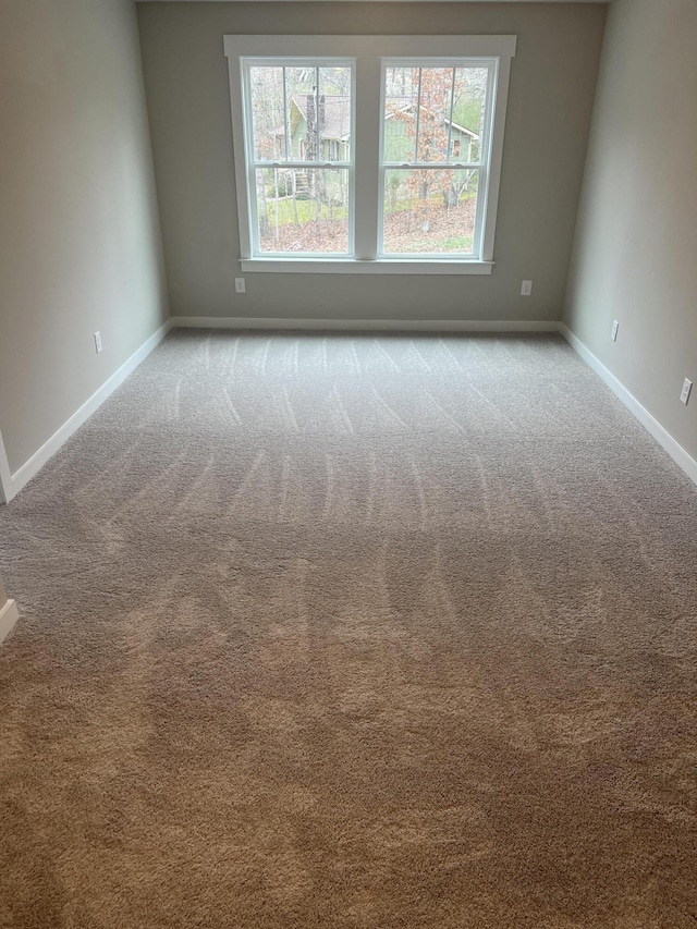 spare room featuring light colored carpet