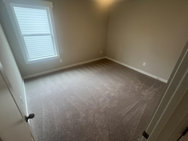 unfurnished room featuring carpet flooring