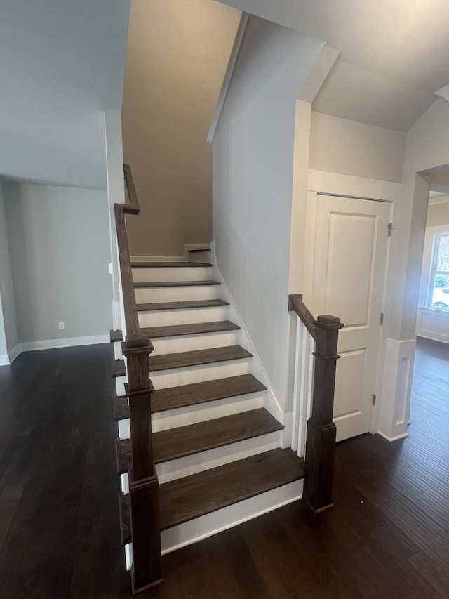 staircase featuring hardwood / wood-style floors and vaulted ceiling