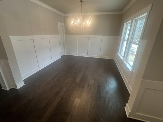 unfurnished dining area with crown molding, dark wood-type flooring, and an inviting chandelier