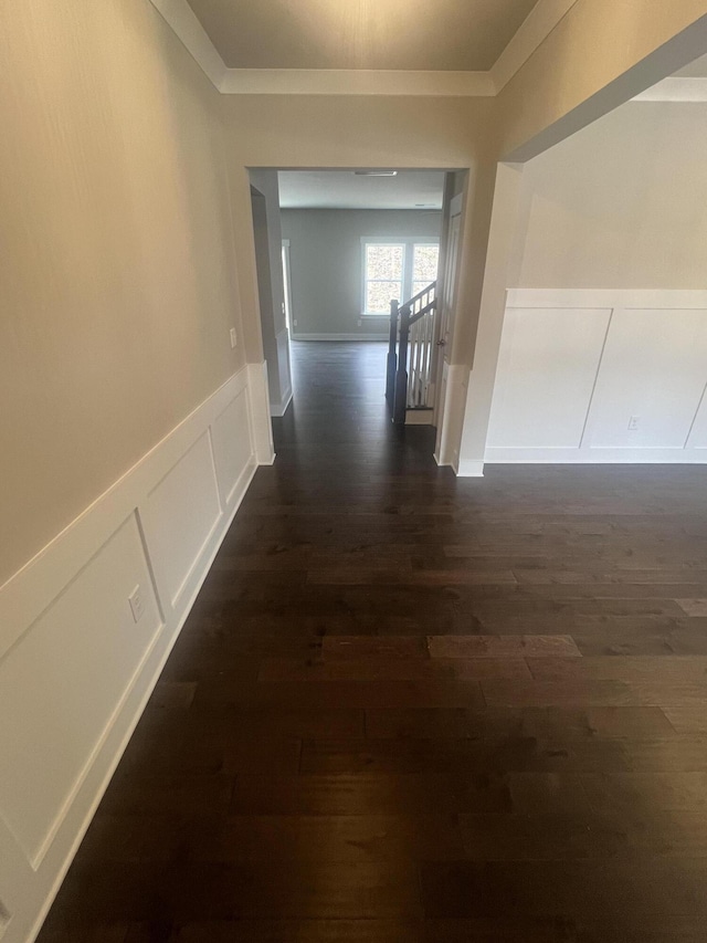 hall featuring crown molding and dark wood-type flooring