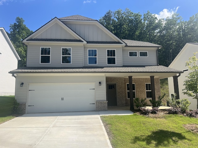 craftsman-style home featuring a porch, a front yard, and a garage