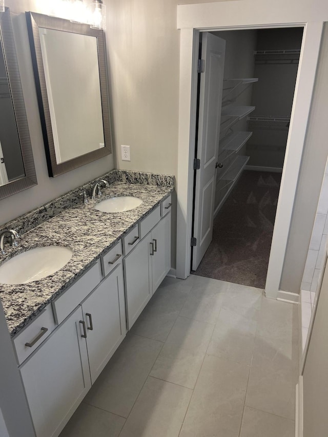 bathroom with tile patterned floors and vanity