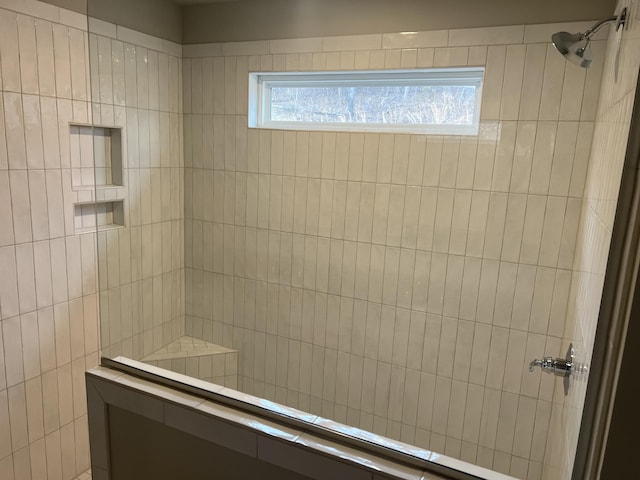 bathroom with a tile shower