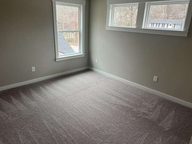 spare room with light colored carpet