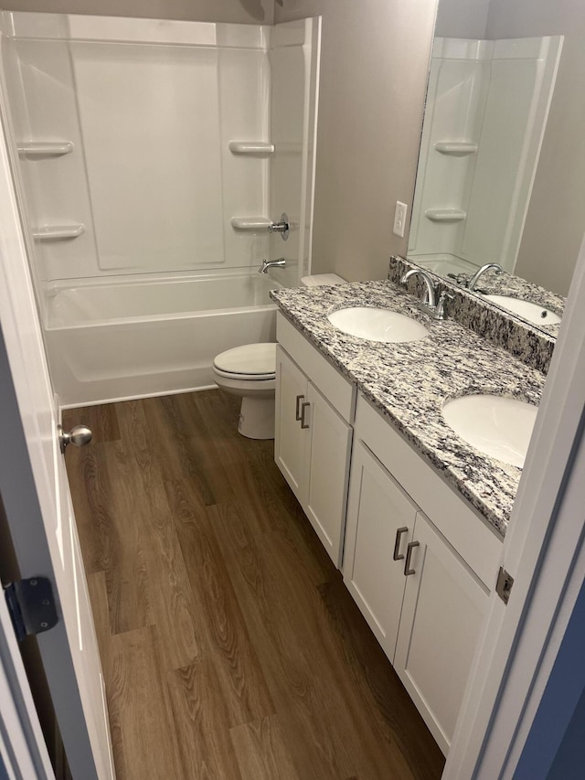 full bathroom with shower / tub combination, hardwood / wood-style floors, vanity, and toilet