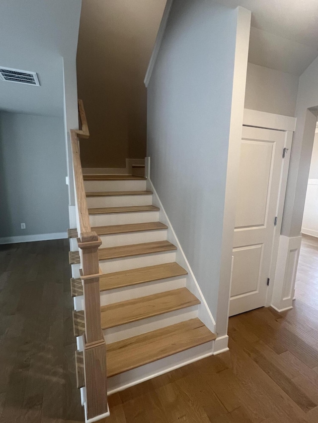 staircase featuring hardwood / wood-style flooring