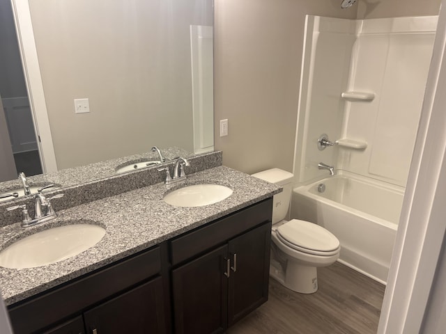 full bathroom with wood-type flooring, vanity, toilet, and tub / shower combination