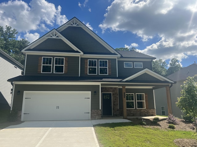 craftsman-style home featuring a garage and a front lawn