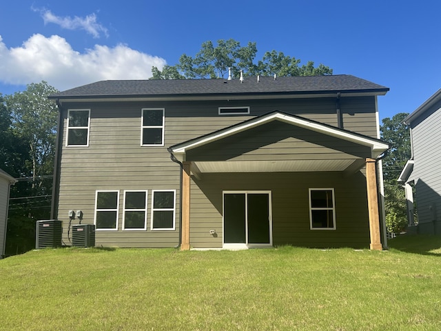 back of house with a lawn and central AC