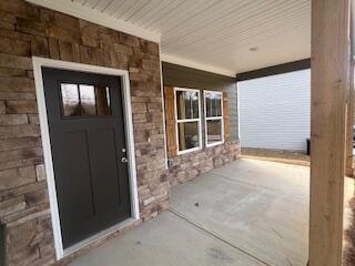 doorway to property featuring a porch