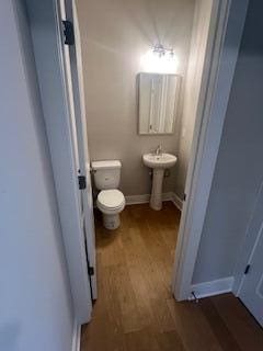 bathroom featuring hardwood / wood-style floors, toilet, and sink