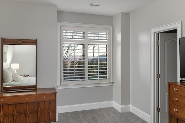 carpeted bedroom featuring visible vents and baseboards