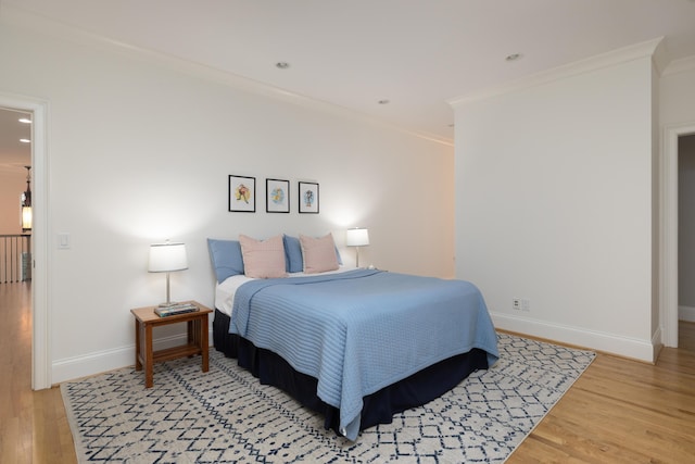 bedroom with crown molding, recessed lighting, baseboards, and light wood finished floors