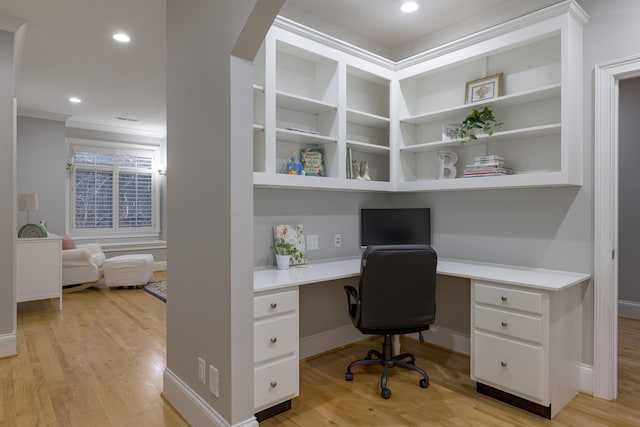 office space featuring recessed lighting, light wood-style floors, and built in desk