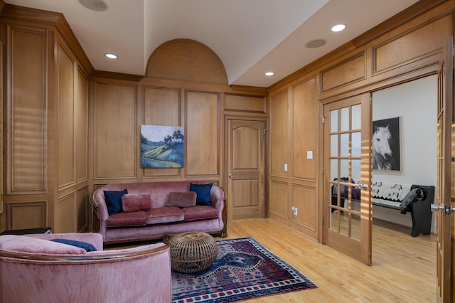 living area with recessed lighting, light wood-type flooring, and a decorative wall