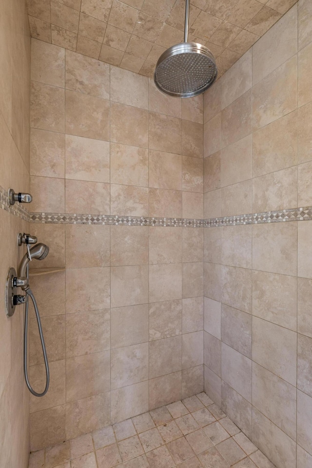 full bath with a tile shower