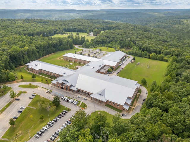 birds eye view of property with a forest view