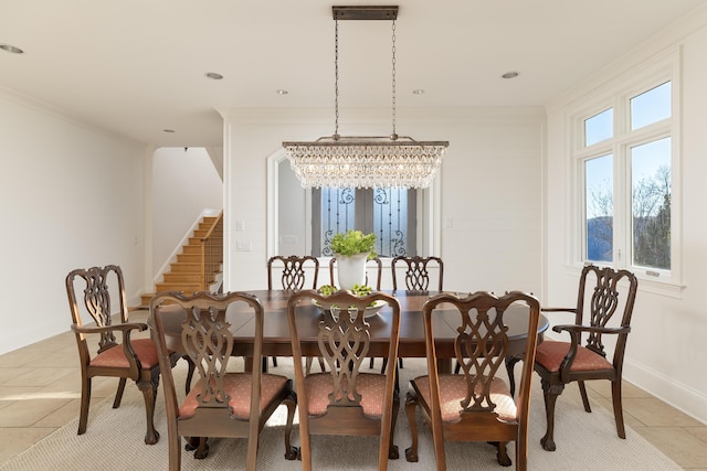 dining room with light tile patterned floors, baseboards, stairs, crown molding, and a notable chandelier