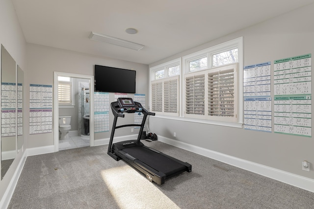 workout area featuring visible vents, baseboards, and carpet flooring