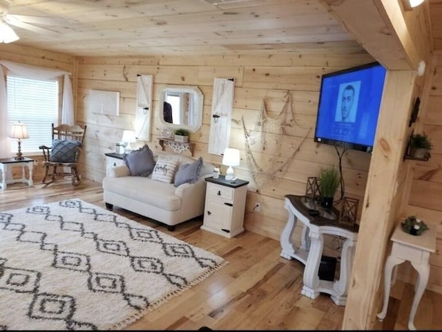 living room featuring wood walls and light hardwood / wood-style floors