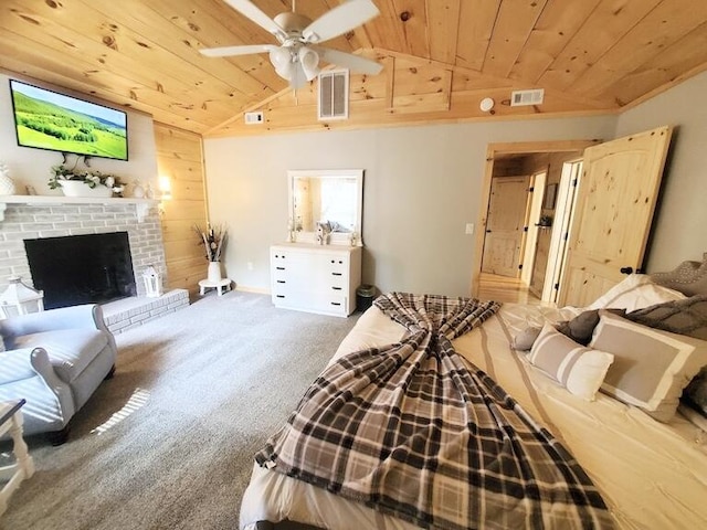 bedroom with ceiling fan, vaulted ceiling, wooden walls, carpet, and wood ceiling