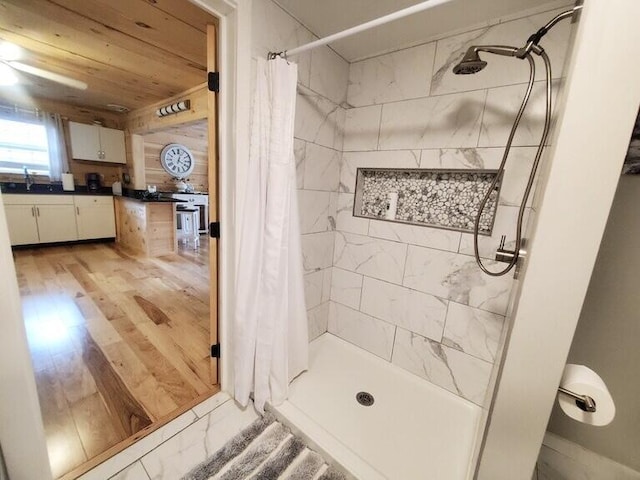 bathroom with sink, wood ceiling, and walk in shower