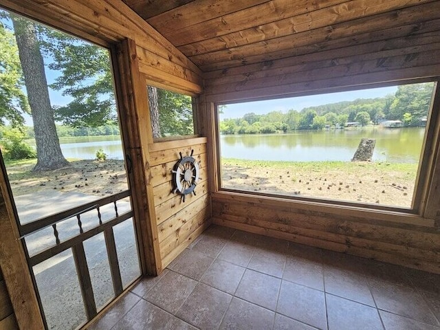 unfurnished sunroom with a water view, wood ceiling, and vaulted ceiling