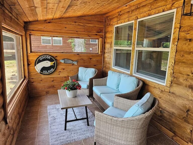 unfurnished sunroom with plenty of natural light, wooden ceiling, and vaulted ceiling