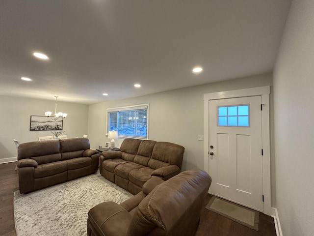 living room featuring dark wood-type flooring and a notable chandelier