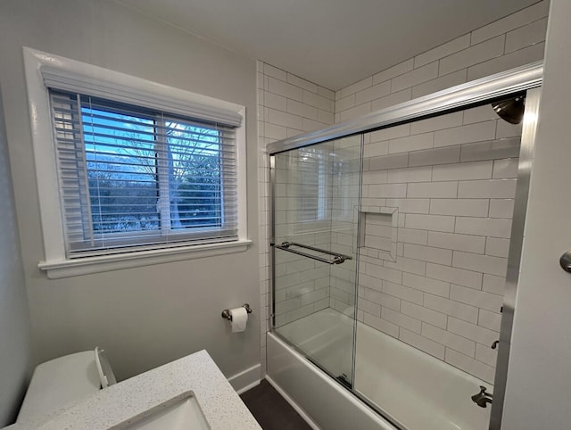 bathroom featuring shower / bath combination with glass door