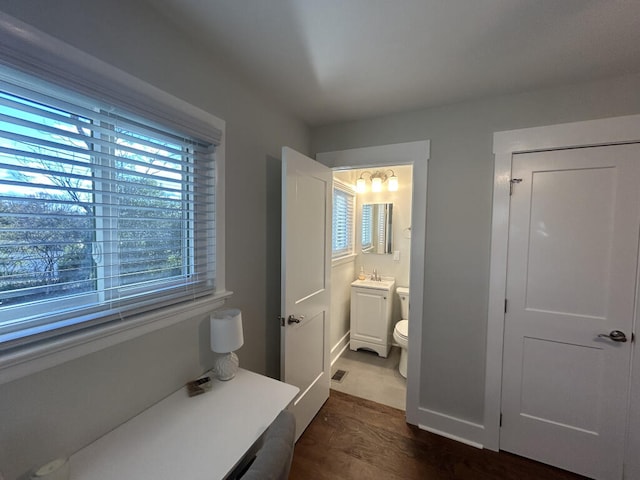 bathroom featuring hardwood / wood-style floors, vanity, and toilet