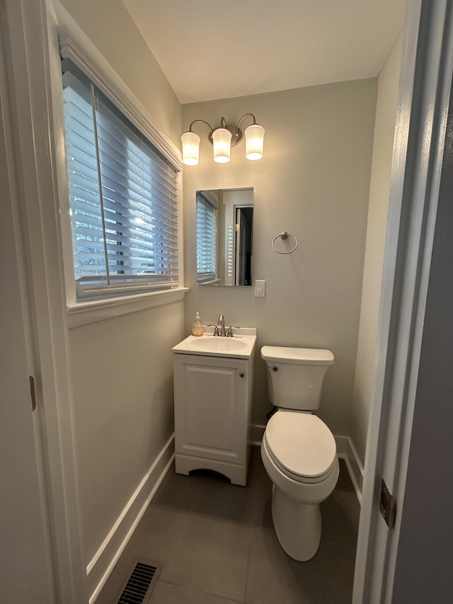 bathroom with tile patterned flooring, vanity, and toilet