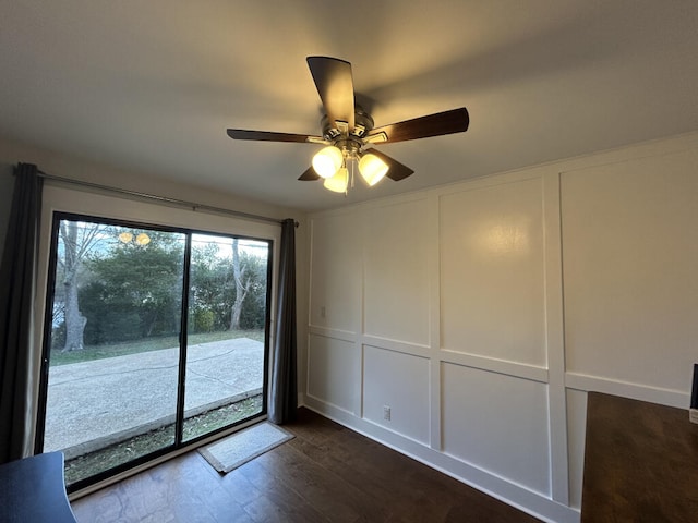 empty room featuring dark hardwood / wood-style flooring and ceiling fan