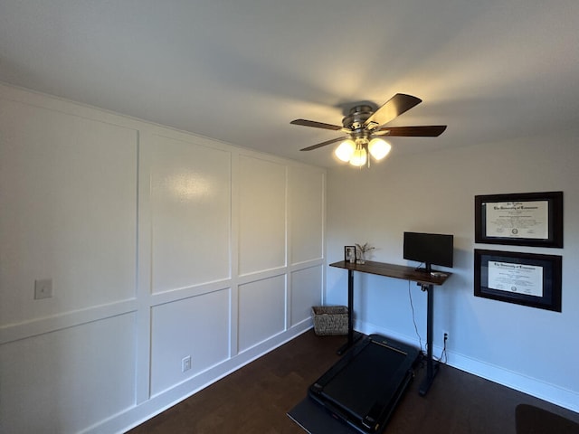 workout room with ceiling fan and dark wood-type flooring