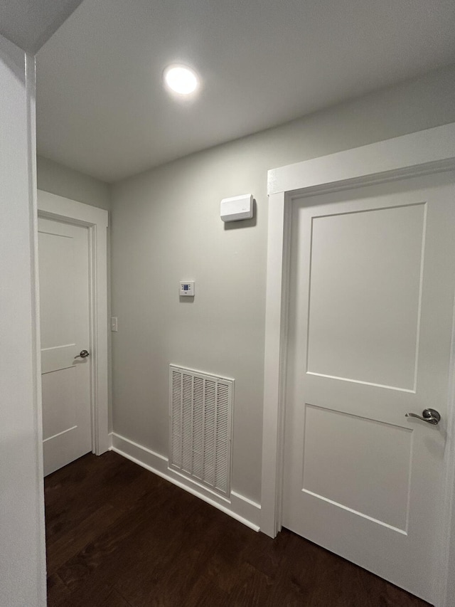 hall with dark wood-type flooring