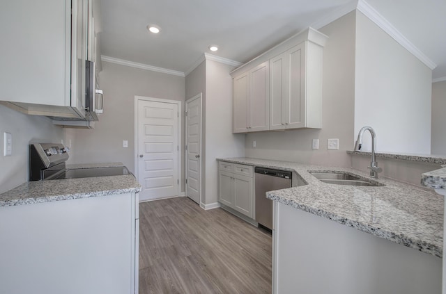 kitchen featuring white cabinets, stainless steel appliances, light stone counters, and sink