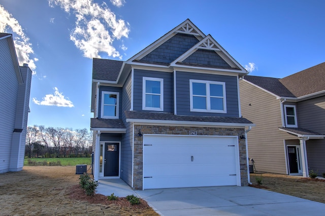 view of front of home featuring a garage and central AC