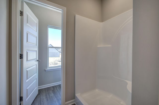 bathroom featuring hardwood / wood-style floors and walk in shower