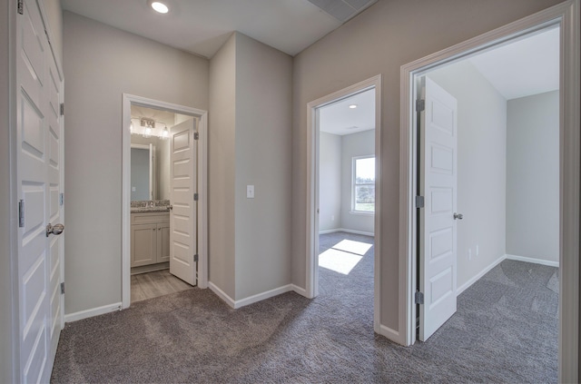 hallway featuring light carpet